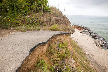 Tarmac road washed away at Happisburgh, North Norfolk, Norfolk, England, United Kingdom, Europe