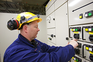 An electrician working a control panel in Krafla geothermal power station, Iceland, Polar Regions