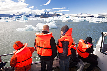 Tourists riding in an amphibious truck at the Jokulsarlon ice lagoon, one of the most visited places in Iceland, Polar Regions