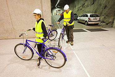 Workers use bicycles to get around the underground plant at the Fljotsdalur hydro power station part of Karahnjukar a massive new contorversial hydro electricity project in North East Iceland, Polar Regions