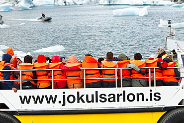 Tourists riding in an amphibious truck at the Jokulsarlon ice lagoon, one of the most visited places in Iceland, Polar Regions