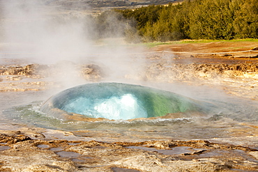 A Geysir a split second before its eruption at Geysir in Iceland, Polar Regions