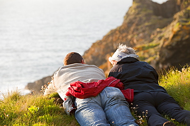 A couple looking out to sea from Botallack on the Cornish coast, Cornwall, England, United Kingdom, Europe