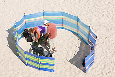 A couple setting up camp on the beach at St. Ives, Cornwall, England, United Kingdom, Europe