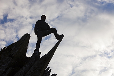 A man climbing on Fleetwith Pike, Lake District, Cumbria, England, United Kingdom, Europe