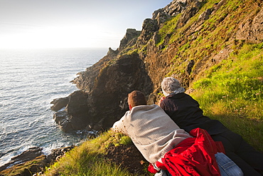 A couple looking out to sea from Botallack on the Cornish coast, Cornwall, England, United Kingdom, Europe