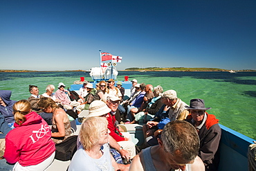 Tourists on a small passenger boat from Tresco to St. Mary's, Isles of Scilly, United Kingdom, Europe