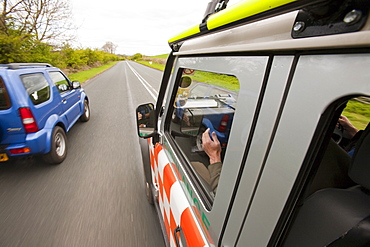 A Land Rover belonging to the Langdale Ambleside Mountain Rescue Team driving under blue lights in an emergency situation, Cumbria, England, United Kingdom, Europe