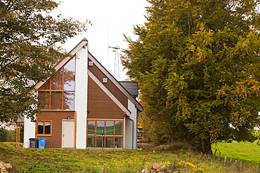 An architect designed eco house with a wind turbine which will provide all the electricity needs of the house near Lesmahagow, Lanarkshire, Scotland, United Kingdom, Europe