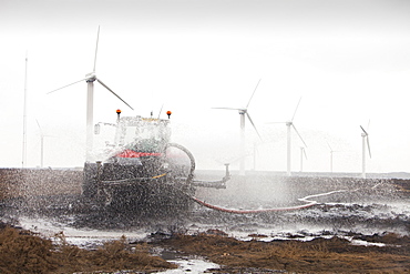 Tractors connected to hose pipes spraying the moorland to damp down the fire on Ogden Moor, near Wainstalls, above Halifax, Yorkshire, England, United Kingdom, Europe