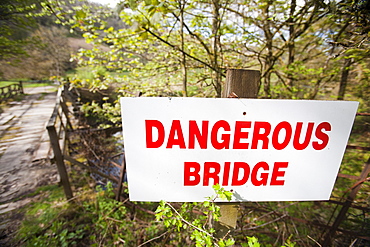 A warning sign about a dangerous bridge in Glen Shira above Loch Fyne in Scotland, United Kingdom, Europe