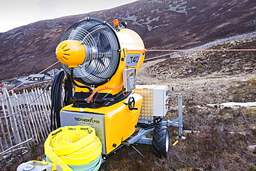 A snow machine in the Cairngorms, surrounded by bare slopes, after poor snow falls in March 2012, Scotland, United Kingdom, Europe