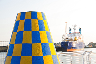 Old buoys with ship in the background at Sunderland Marina, Wearmouth, Tyne and Wear, England, United Kingdom, Europe