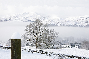 Snow and valley mist over Ambleside in the Lake District, looking towards Wetherlam, Cumbria, England, United Kingdom, Europe