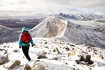 A female hill walker on the hills behind Broadford looking towards the Cuillin ridge on the Isle of skye, Scotland, United Kingdom, Europe