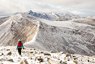 A female hill walker on the hills behind Broadford looking towards the Cuillin ridge on the Isle of skye, Scotland, United Kingdom, Europe