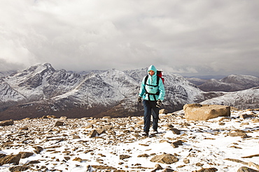 A female hill walker on the hills behind Broadford looking towards the Cuillin ridge on the Isle of skye, Scotland, United Kingdom, Europe