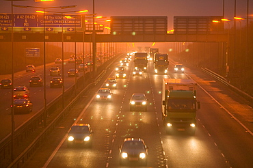 Cars driving in evening fog on the M1 motorway near Loughborough, Leicestershire, England, United Kingdom, Europe