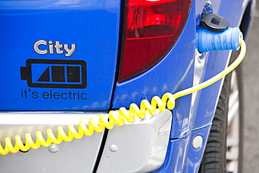 An electric vehicle at a recharging station on the street in Berkeley Square, London, England, United Kingdom, Europe