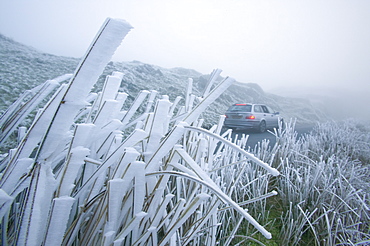 A car driving over Wrynose Pass in fog, Lake District, Cumbria, England, United Kingdom, Europe