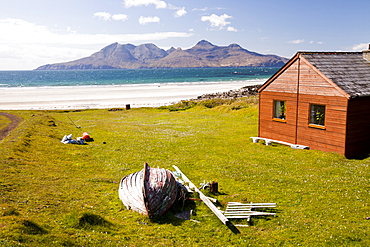 A house at Laig Bay on the Isle of Eigg, looking towards the Isle of Rhum, Scotland, United Kingdom, Europe