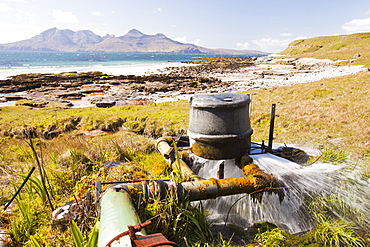 A home made hydro turbine on the Isle of Eigg , with the Isle of Rhum in the background, Scotland, United Kingdom, Europe