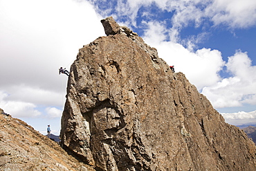 Climbers abseiling from the summit of the Inaccessible Pinnacle onto Sgurr Dearg in the Cuillin mountains, Isle of Skye, Scotland, United Kingdom, Europe