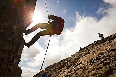 Climbers abseiling from the summit of the Inaccessible Pinnacle onto Sgurr Dearg in the Cuillin mountains, Isle of Skye, Scotland, United Kingdom, Europe