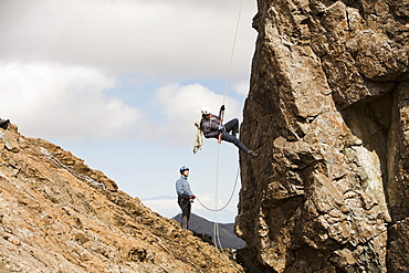 Climbers abseiling from the summit of the Inaccessible Pinnacle onto Sgurr Dearg in the Cuillin mountains, Isle of Skye, Scotland, United Kingdom, Europe