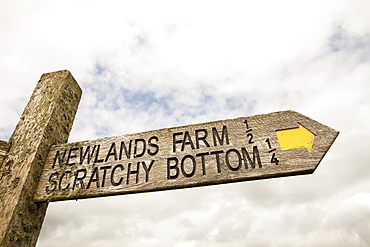 A signpost on the Dorset coast for the funnily named Scratchy Bottom, near Lulworth, Dorset, England, United Kingdom, Europe