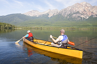 A father and son in a Canadian canoe on Pyramid Lake near Jasper, Jasper National Park, UNESCO World Heritage Site, Alberta, Canadian Rockies, Canada, North America