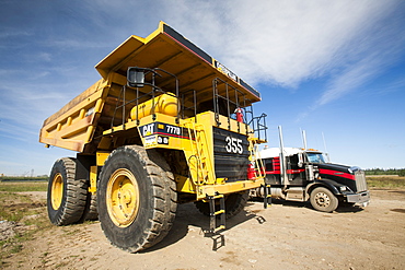 Massive dump trucks by the Syncrude upgrader plant, Alberta, Canada, North America