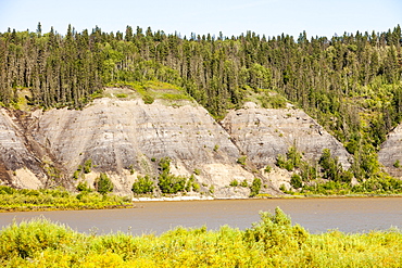 Tar sands deposits exposed in the side of the Athabasca River, Fort McMurray, Alberta, Canada, North America