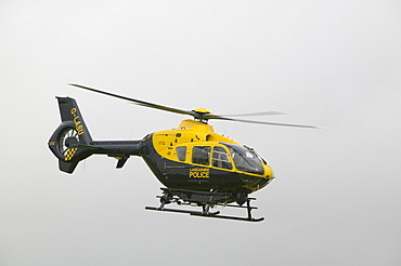 A police helicopter flies over the Grayrigg train crash site near Kendal, Cumbria, England, United Kingdom, Europe