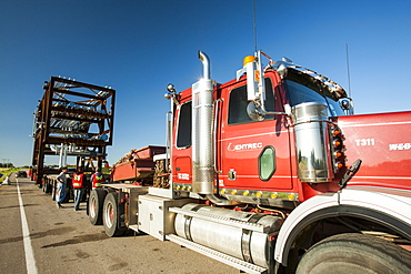 Trucks haul an oversize load of tar sands equipment for a SAGD mine, on the road towards Fort McMurray, the centre of the tar sands industry, Alberta, Canada, North America