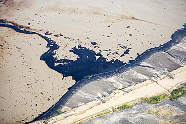 The tailings pond at the Syncrude mine north of Fort McMurray, Alberta, Canada, North America