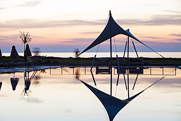 A holiday complex swimming pool at dusk in Myrina on Lemnos, Greek Islands, Greece, Europe