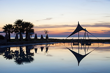 A holiday complex swimming pool at dusk in Myrina on Lemnos, Greek Islands, Greece, Europe