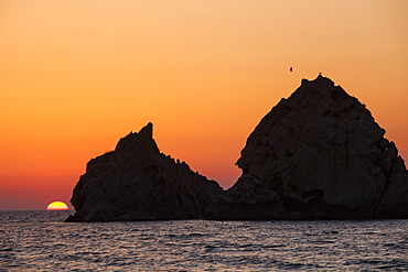 Sunset over rocky islands off Myrina on Lemnos, Greek Islands, Greece, Europe