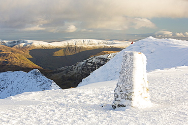 The summit trig point covered in hoar frost on Helvellyn in the Lake District National Park, Cumbria, England, United Kingdom, Europe