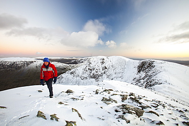 Looking towards Dollywagon Pike and Fairfield from Helvellyn at sunset, with a lone hill walker, Lake District National Park, Cumbria, England, United Kingdom, Europe