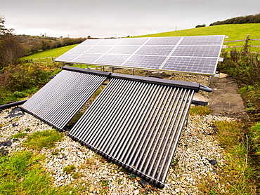 Solar photo voltaic panels and solar thermal panels providing electricity and hot water for a farm house on Bodmin Moor, Cornwall, England, United Kingdom, Europe