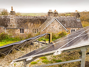 Solar photo voltaic panels and solar thermal panels providing electricity and hot water for a 16th century farm house on Bodmin Moor, Cornwall, England, United Kingdom, Europe