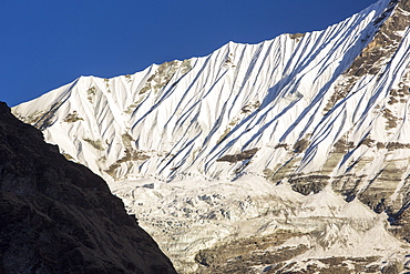 A rapidly retreating glacier on the side of the 6428 metre peak of Gandharwa Chuli in the Annapurna Sanctuary, Nepalese Himalayas, Nepal, Asia