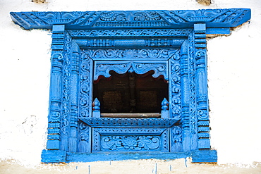 An intricately carved window in the old traditional village of Ghandruk in the Nepalese Himalayas, Nepal, Asia