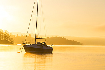 Sailing boats on Lake Windermere at sunrise with will o wisp mist, Waterhead, Ambleside, Lake District National Park, Cumbria, England, United Kingdom, Europe