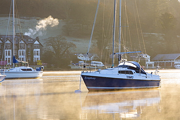 Sailing boats on Lake Windermere at sunrise with will o wisp mist, Waterhead, Ambleside, Lake District National Park, Cumbria, England, United Kingdom, Europe