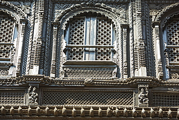 Ancient ornately carved wood window frames on an old building in Kathmandu's Durbar Square, UNESCO World Heritage Site, Kathmandu, Nepal, Asia