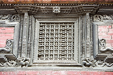 Ancient ornately carved wood window frames on an old building in Kathmandu's Durbar Square, UNESCO World Heritage Site, Kathmandu, Nepal, Asia