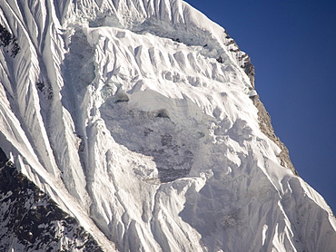 A gaping hole left where a massive block of ice detached causing an avalanche on Machapuchare (Fishtail Peak) in the Annapurna Himalaya, Nepal, Asia